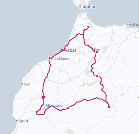 Map of a travel route in Morocco, highlighting key cities including Rabat and Marrakesh, with a pink line indicating the path through various regions.